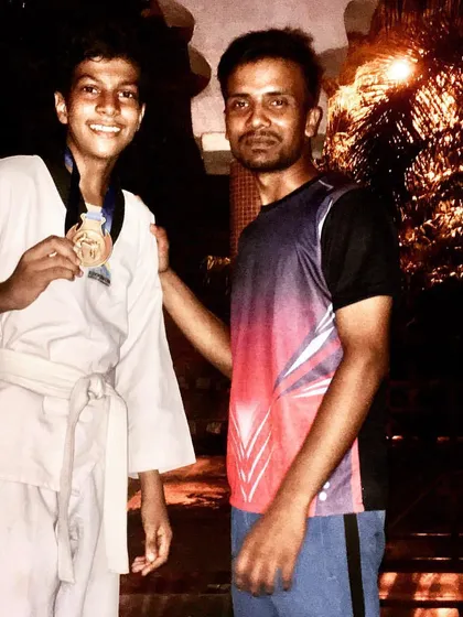 This student's smile shows the satisfaction of a well-earned victory. Each medal represents a personal milestone and a step forward in their martial arts journey.