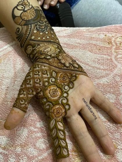 Another angle of the Teej festival design, showing the combination of peacock, floral, and geometric patterns on the hand.