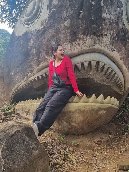 A fun photo op at the fish-shaped rock in Wayanad. Our trips are full of quirky and memorable spots.
