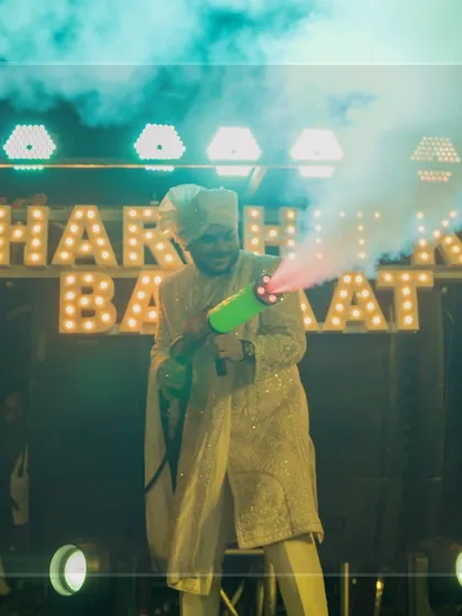 The groom leading his baraat with a CO2 smoke gun. I love adding these fun, high-energy elements to make the groom's procession an unforgettable party.
