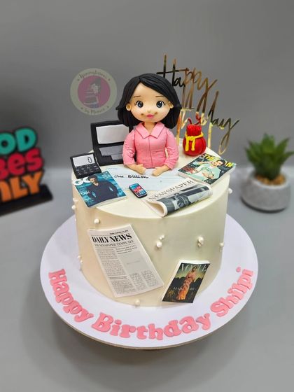 Another angle of the PR-themed cake, showcasing the detailed edible prints and fondant accessories.