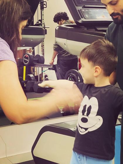 A close up of a pediatric physiotherapy session. The therapist and parent work together to encourage the child, creating a supportive and positive environment for them to conquer new milestones.