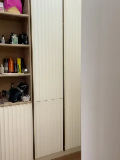 A side view of the fluted wardrobe, showing the open shelving section perfect for perfumes and accessories.