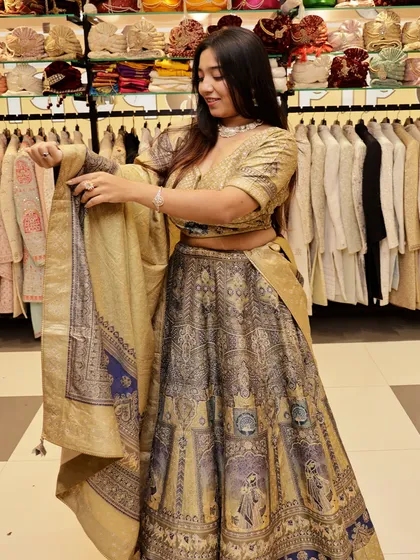 A closer look at the details of this golden and grey lehenga, showing the quality of the fabric and print.