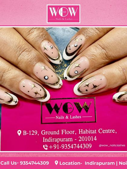 A celestial-inspired design with a modern twist. This look features a French manicure with gold and white tips, accented with intricate star and moon details.