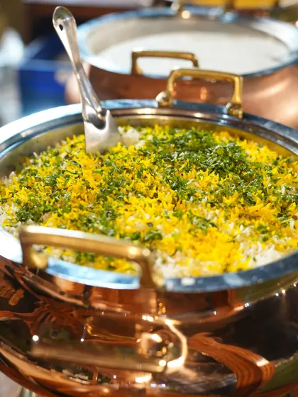 A stunning copper handi filled with fragrant, saffron infused biryani, garnished with fresh herbs. This is how we present our classic Indian main courses.