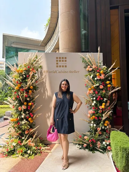 Attending the relaunch of The Qube at The Leela Palace. I paired a simple navy dress with a pop of color from my pink bag for a chic and polished event look.