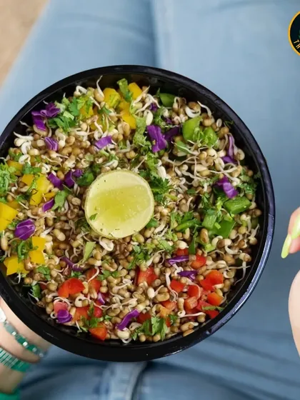 A salad should be a rainbow of nutrients. This sprout salad is packed with colorful bell peppers, red cabbage, and fresh herbs, all brought together with a zesty squeeze of lime.