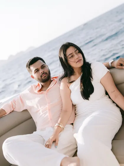 A candid moment of the couple seated together on the yacht in Oman, enjoying the sea breeze.