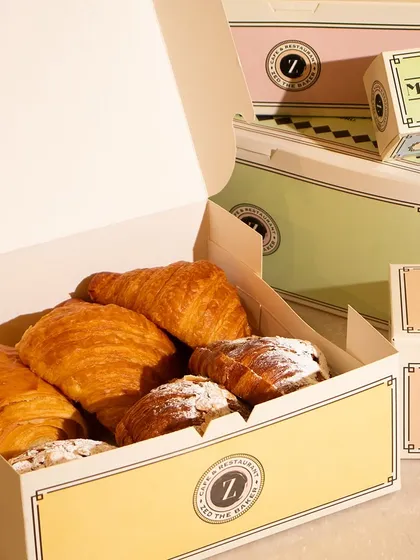 A box of my freshly baked croissants and pastries, ready for takeaway. My sturdy and stylish packaging ensures your treats travel safely and arrive looking as good as they taste.