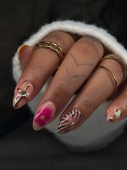 A close-up on some of the hand-painted details from the mismatched set, including a vibrant pink floral and an abstract zebra-like pattern.