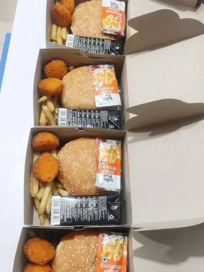 Our snack boxes are not just about traditional Indian fare. We also offer fun options like these boxes with a veg burger, cheese nuggets, and french fries, making them a hit at birthday parties and casual corporate events.