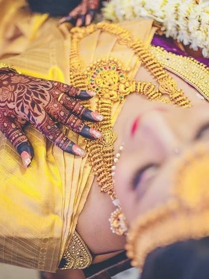 After women, mehendi is the most divine creation. A beautiful artistic shot of a bride, her hennaed hand resting on her chest.