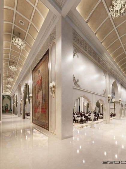 The grand scale of the banquet hall is evident in this wide view, showcasing the massive arches, ornate wall moldings, and coffered ceilings. The design seamlessly blends Rajasthani and Islamic architectural elements for a truly majestic experience.