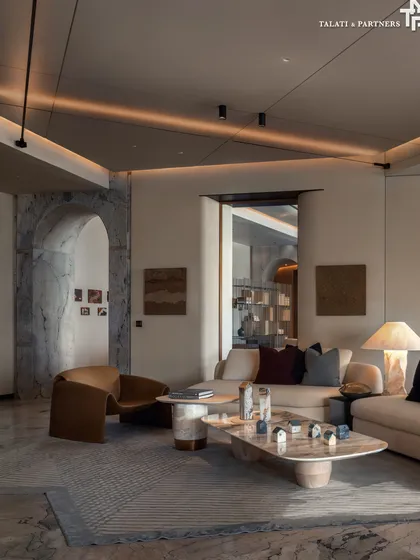 An address as rare as its design, the Palais Royale showflat living room embodies the pinnacle of curated luxury. A sculptural coffee table becomes the focal point, anchoring the seating arrangement in a dialogue between form and texture.