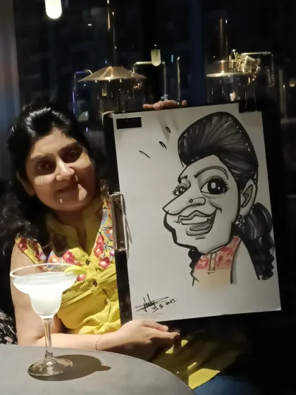 A guest enjoying a drink at Nincasa with her new caricature.