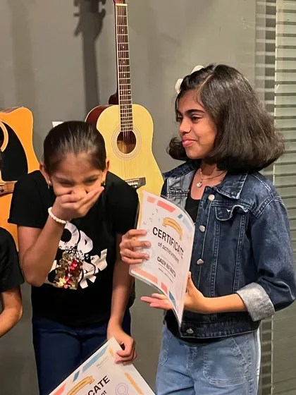 The excitement of receiving a certificate of achievement. We celebrate every student's progress, and these moments of pride are what make our kids' programs so special.