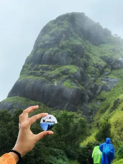 A creative shot of the Kurinjal peak with our trek badge. It’s a challenging climb but the views from the top are a fantastic reward.