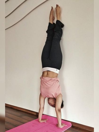 A glimpse of strength and balance from our regular classes. This student holds a steady handstand against the wall, a testament to consistent practice.
