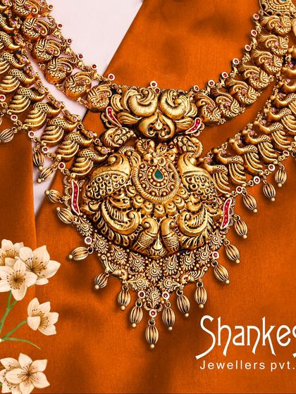 This grand temple necklace features elaborate peacock motifs, a popular and auspicious design in heritage jewellery. The sheer scale and detail make it a centerpiece for any collection.