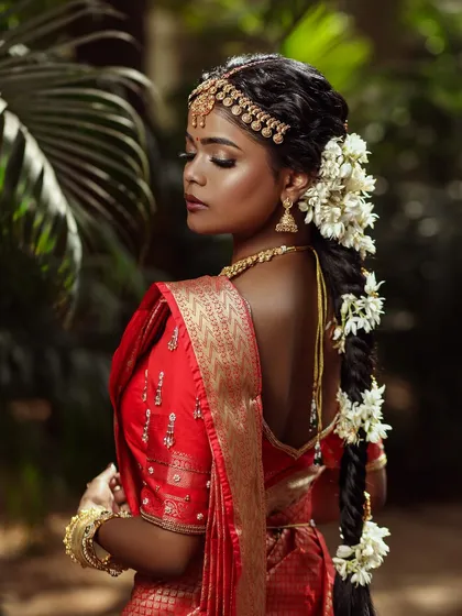 The elegance of a traditional South Indian bride. I ensured her skin had a dewy, almost luminous quality to it, which photographs beautifully against the lush green background.