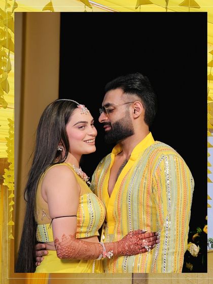 An intimate portrait of the couple during their Haldi ceremony. They share a loving gaze, a quiet moment of connection amidst the joyful celebrations surrounding them.
