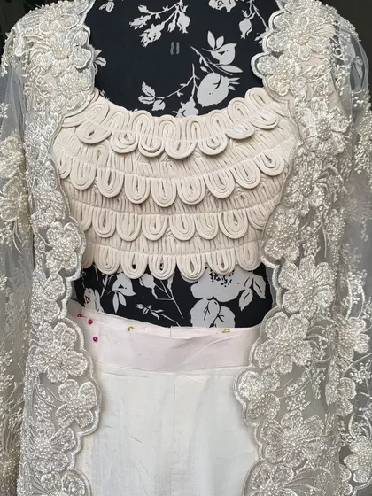 A detailed shot of the jacket's embroidery. Each flower is crafted with tiny pearls and threads.