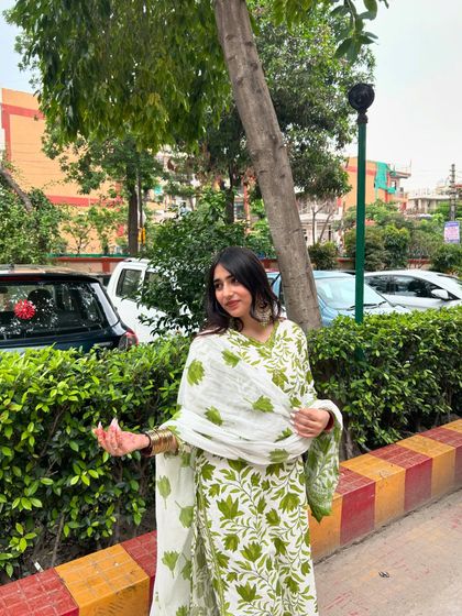 A simple and elegant green and white printed suit. This is a great example of a comfortable yet stylish outfit for a daytime family gathering.