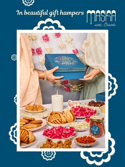 A beautiful spread showcasing our Diwali gift hampers. The elegant blue boxes are designed to be a gift in themselves, filled with an assortment of our festive collection.