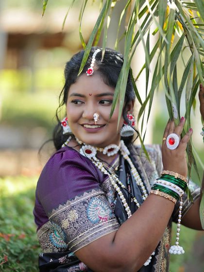 Another angle showing the details of the puffed-sleeve blouse and the intricate design of the nath.