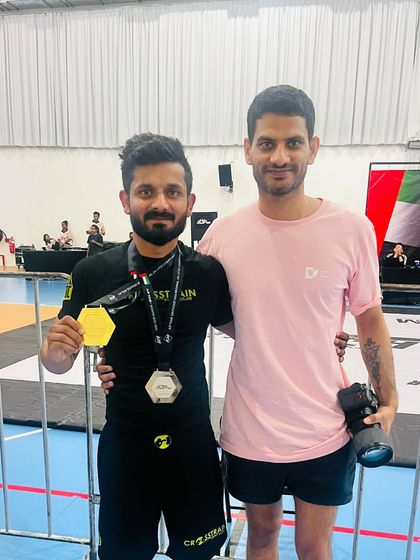 A moment with the coach after a big win. The victory belongs to the athlete, but the journey is shared by the whole team.