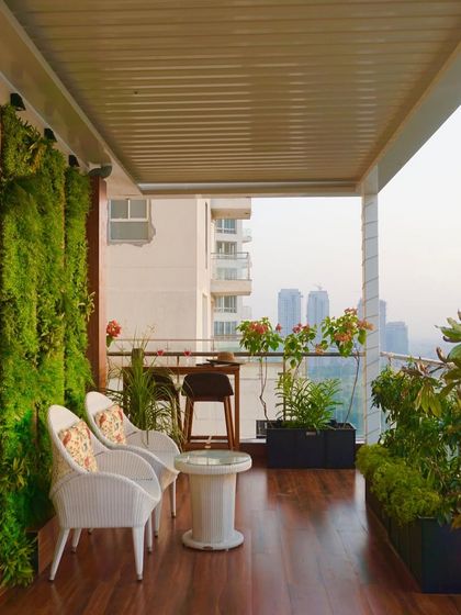 From this angle, you can see how the different elements of the terrace work together. The rich wooden flooring leads the eye from the cozy seating nook past the bar area towards the open view, creating a seamless flow.