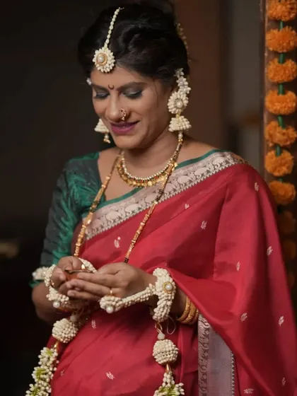 A classic look for Hartalika or other pujas. This client is wearing our elegant white floral jewellery with her beautiful red saree.