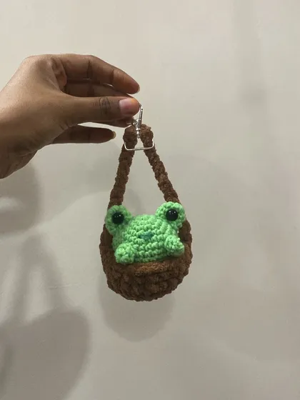 This little green frog peeking out of a brown pouch is one of my most loved keychain designs. It's so full of personality and is sure to make you smile.