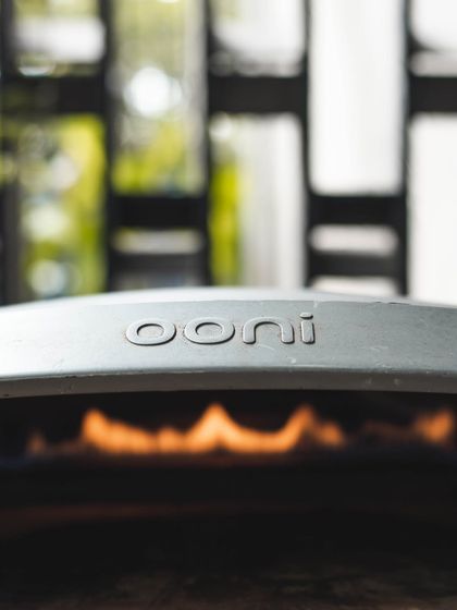 A close-up of the Ooni oven, fired up and ready to go. These powerful little ovens allow us to offer an authentic pizza catering service for events of any size.