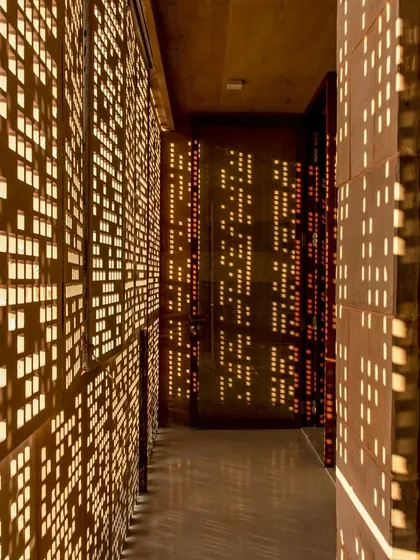Light is not a utility but a material to be sculpted. Here, in the House of Solid Stone, hand-cut stone screens, or jaalis, transform sunlight into a dynamic pattern, bringing life and movement to the interior spaces while ensuring privacy and thermal comfort.