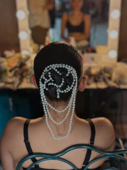 To show my creative range, here is a unique bun I designed for a designer campaign. I crafted a sleek, low bun and then draped it with an intricate net of pearls. This is a great example of how accessories can transform a simple updo into a work of art.