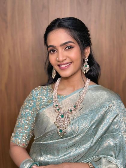 A timeless and simple look featuring a soft, winged liner and a unique saree drape.