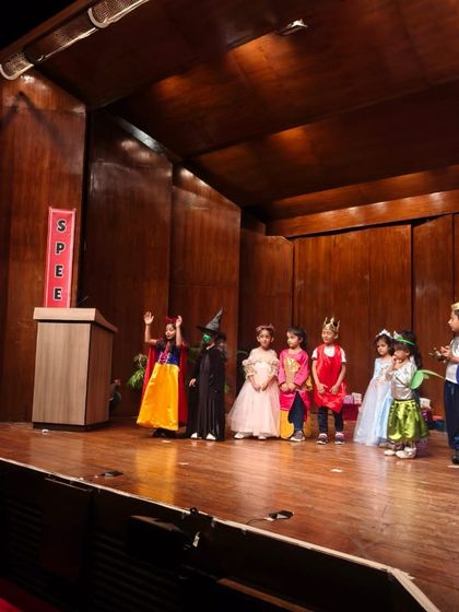 Our fairytale characters line up on stage, showcasing their beautiful costumes and confident smiles.
