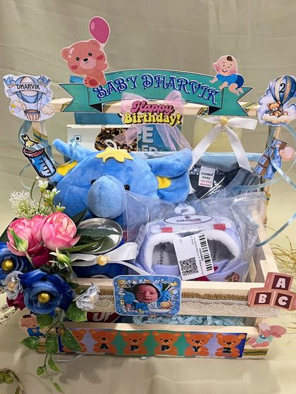 Another angle of the 2 month milestone hamper, highlighting the wooden crate and the arrangement of gifts inside. The open design makes it a beautiful display piece.