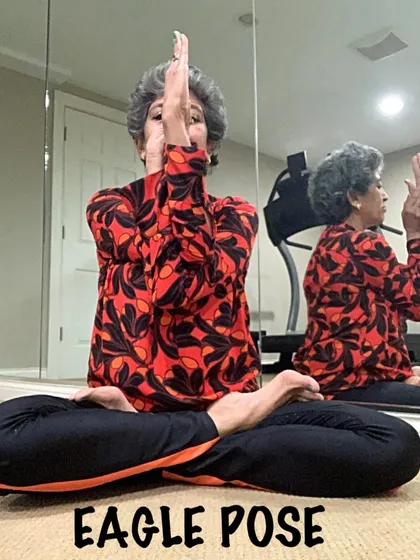 Another view of Eagle Pose arms, showing the reflection which helps to check alignment.