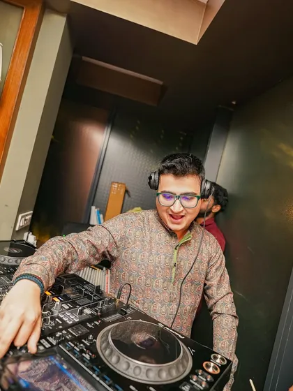 A close-up shot, focused on the mixer during a high-energy club night.