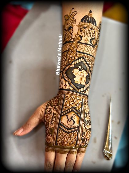 A detailed engagement back-hand design, featuring cute couple figures, peacocks, and the couple's initials.