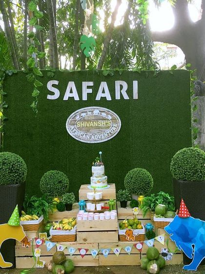 A classic safari adventure birthday entrance. I used a faux grass backdrop, wooden signs pointing to different "animal zones," and colorful animal cutouts to set the stage for fun.