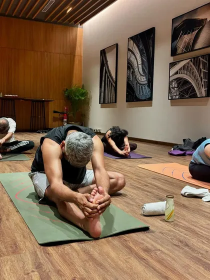 A student in Janu Sirsasana (head-to-knee pose) at our Gurgaon class. This posture stretches the hamstrings and back while calming the nervous system.