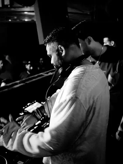 A black and white photo of me in the zone, hands on the mixer, preparing for a big weekend of shows.