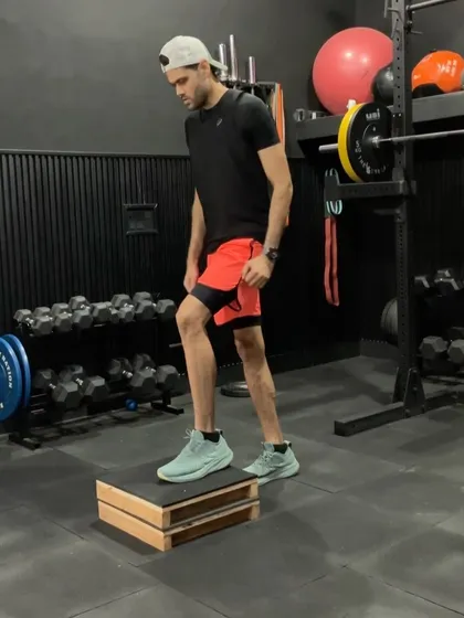 An athlete performing a box jump. This is a classic plyometric exercise for developing vertical power and explosiveness, a key attribute for any cricketer.