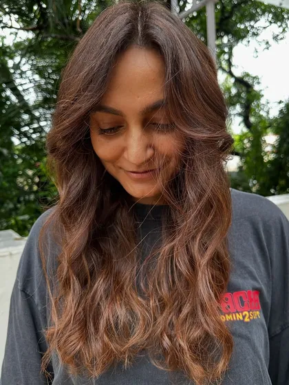 Getting her ready for a work trip with a professional yet stylish look. These 'Almond Brown' tresses are chic and sophisticated, with just enough color to feel fresh and confident.