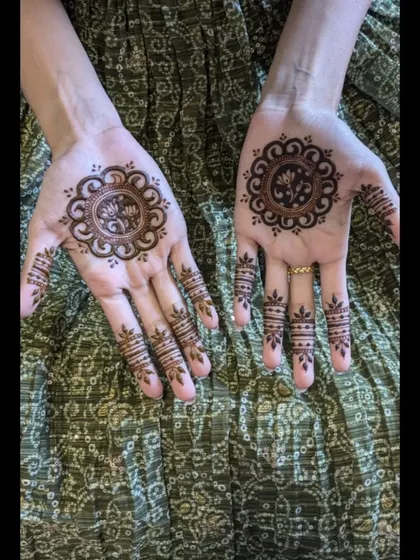 A closer look at the matching mandala designs for the bride's sister. The central lotus is surrounded by a simple, clean border.