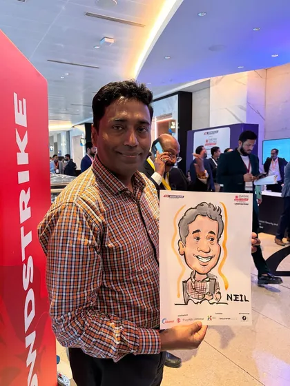 An attendee at a professional event proudly displays his caricature, a unique memento from the day.